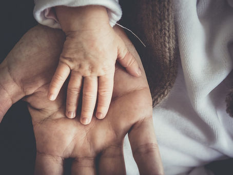Parent holding a child’s hand symbolizing caregiving, emotional connection, and the challenges of parenting burnout