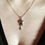 Thumbnail: Model wearing  sterling silver bluebell topaz pendant