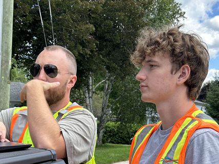 William and Chris Piraine reviewing site information in the field during a private utility locate on private property