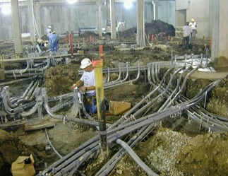Conduit buried beneath a floor inside a building.
