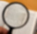 Magnifying glass on a portion from the Hebrew Bible (Deuteronomy). Selective focus on ver
