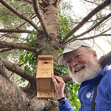 Dave Galvin points to a recently installed birdhouse.jpeg