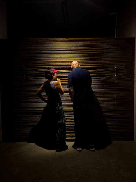 two people in front of rope made wall