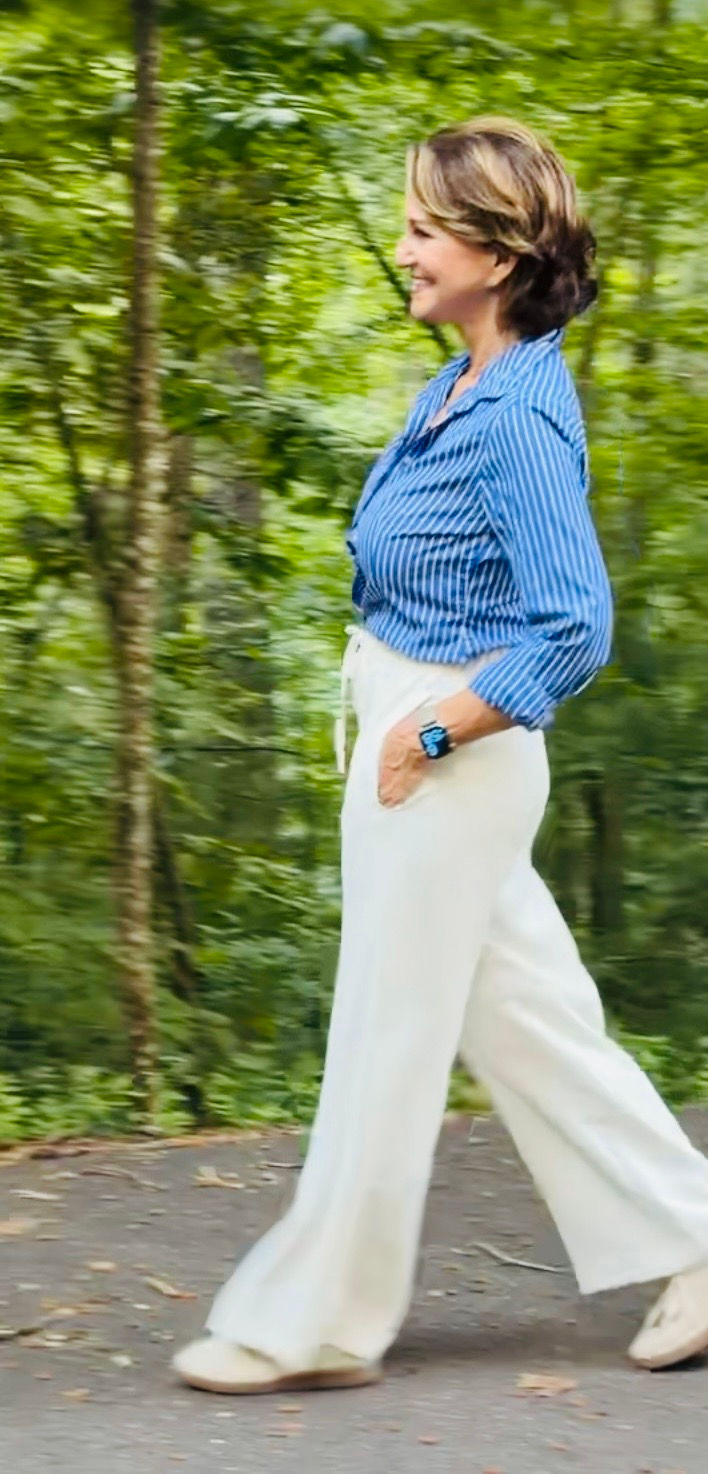 petite woman modeling a vertical- striped blouse