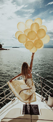 woman-dress-standing-yacht-holding-golden-balloons-while-sailing (1).jpg