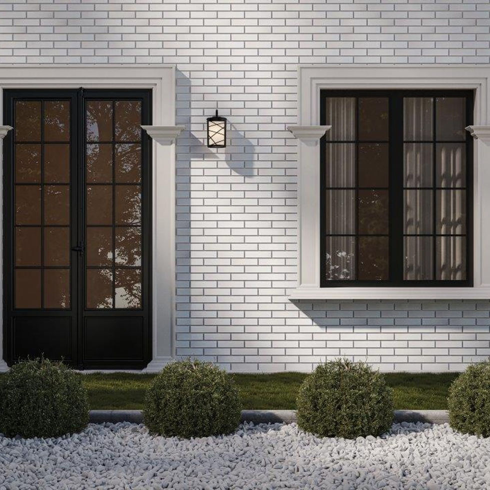 Façade en briques blanches avec porte et fenêtre noires.