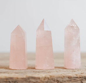 vecteezy_polished-crystals-rose-quartz-gemstone-on-a-wooden-table_5121494.jpg