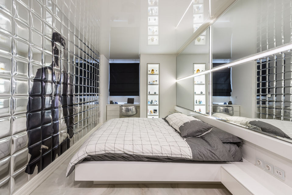Bedroom with big wall mirror
