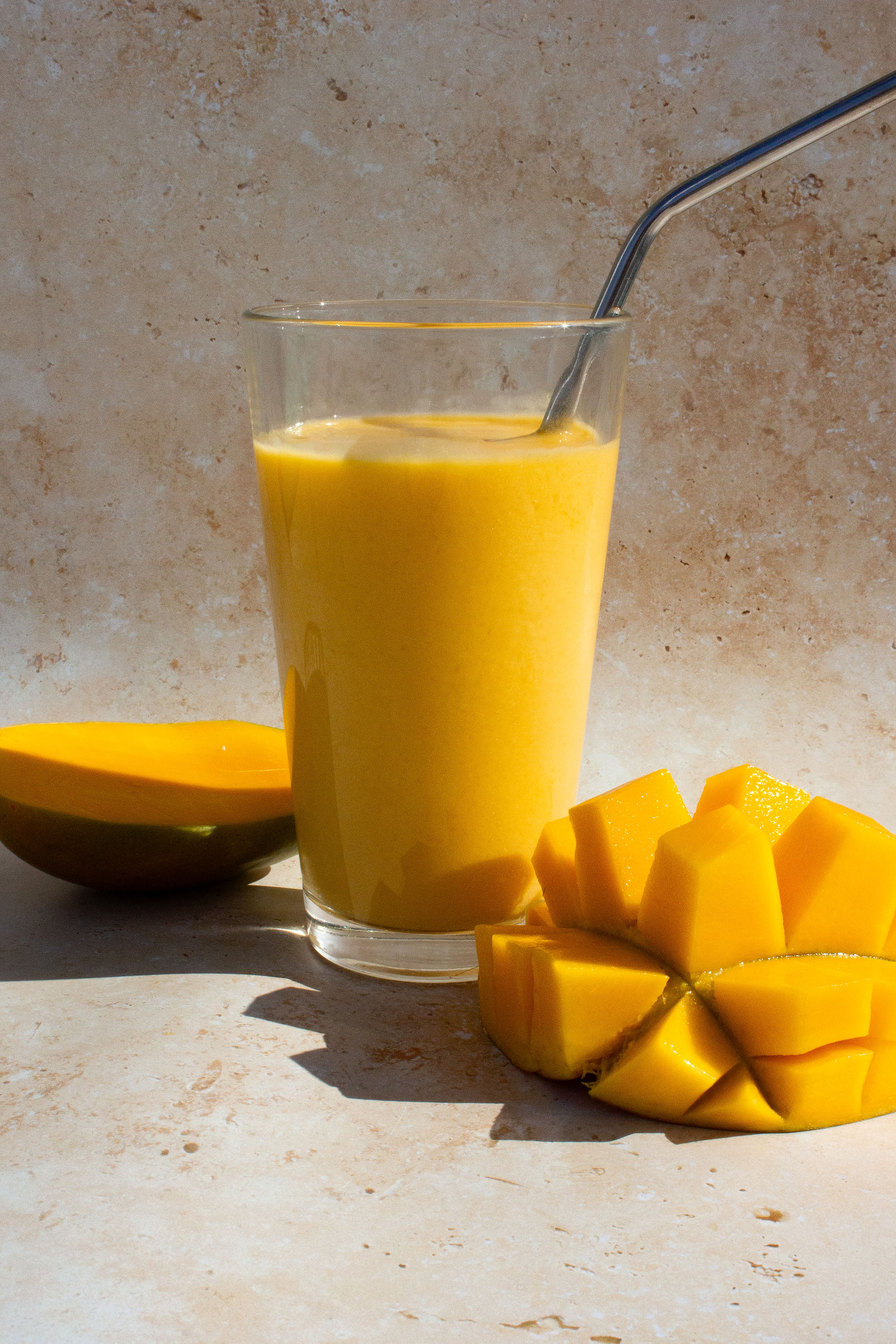 Creamy dairy-free mango smoothie made with fresh mango, oat milk, and agave nectar.