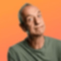 Arthur Smith smiling with his arms crossed, exuding confidence and warmth.
