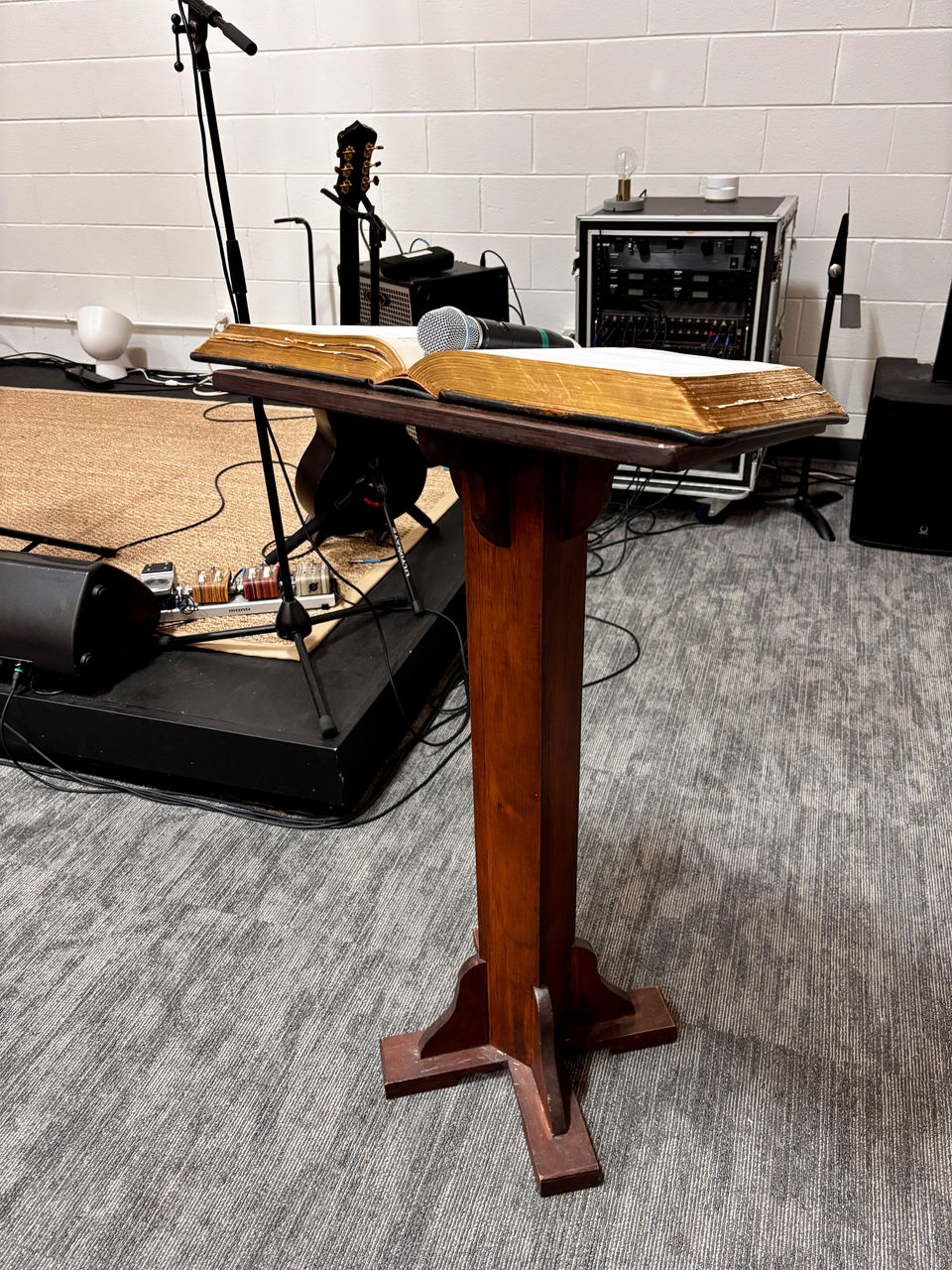 A podium with a book and microphone in the sanctuary.