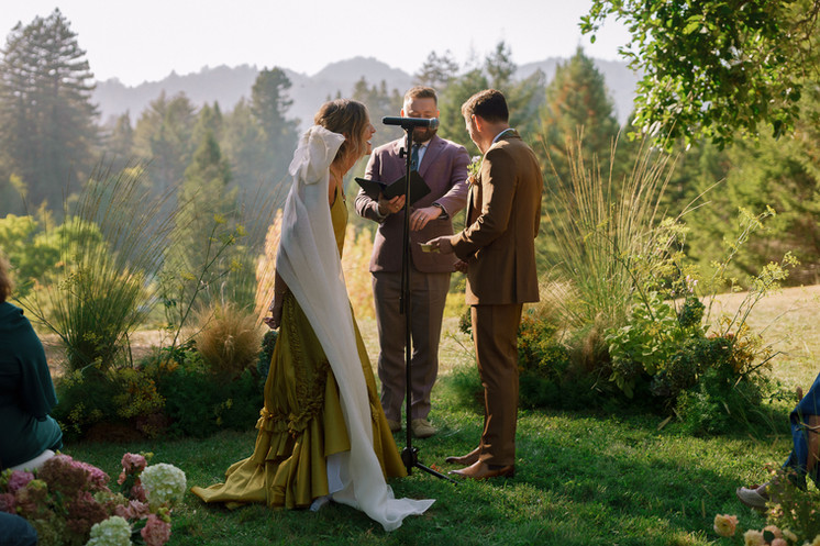 Outdoor wedding ceremony trees and forest backdrop with natural sunlight on the Stavrand property in Guerneville.