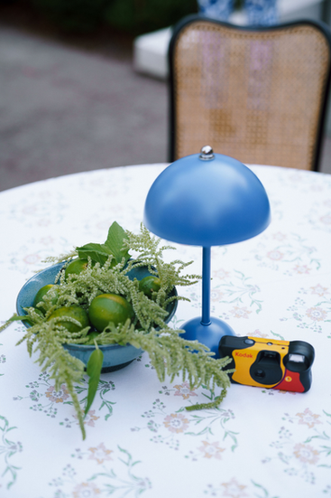 wedding welcome party table with limes centerpiece, table lamp, and disposable camera