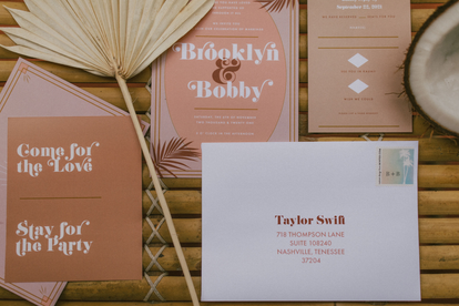 pink tropical wedding suite flatlay 