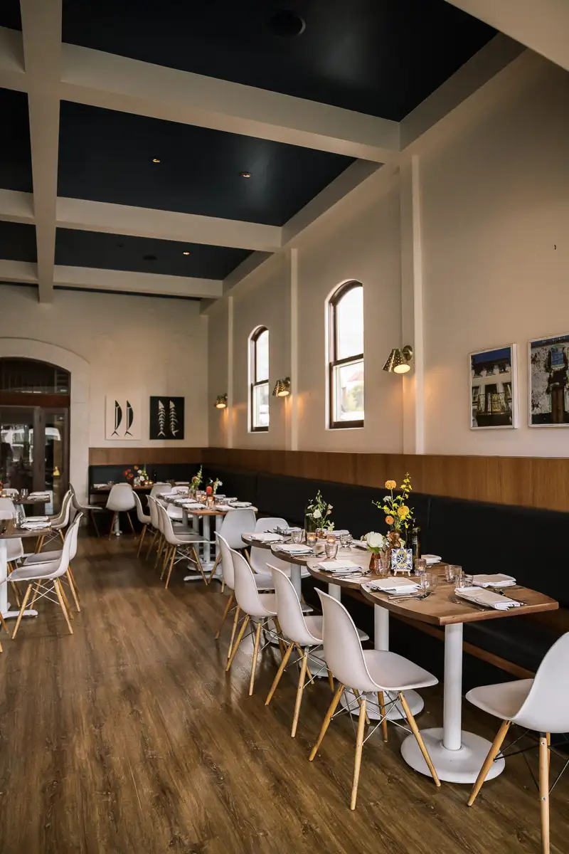 long table reception setup inside san francisco restaurant wedding with modern table design