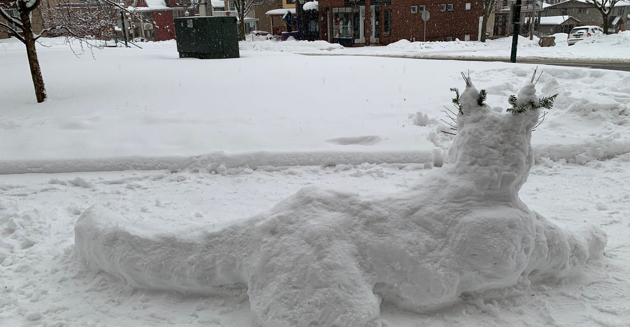 A Snow Sculpture - Big Cat with pine needle whisker and ear flourishes