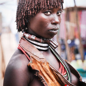 The beauty of red dreadlocks
"A Hamer woman with ochre-dyed dreadlocks, reflecting her tribe's reverence for beauty, nature, and the land. The mixture of red ochre and butter symbolizes fertility and life, creating a striking aesthetic."
