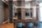 Modern dining room with custom built-in storage, marble finishes, and luxury interior design.