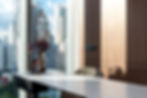 Modern dining area with custom built-in furniture, contemporary interior styling, and city skyline view.