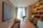 Modern luxury home office with bespoke desk, custom shelving, natural wood finishes, and contemporary interior design.