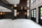 Luxury double-volume living hall with marble flooring, custom wall panels, and modern architectural design.