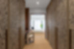 Modern hallway with custom wood paneling, built-in storage, and contemporary interior architecture.