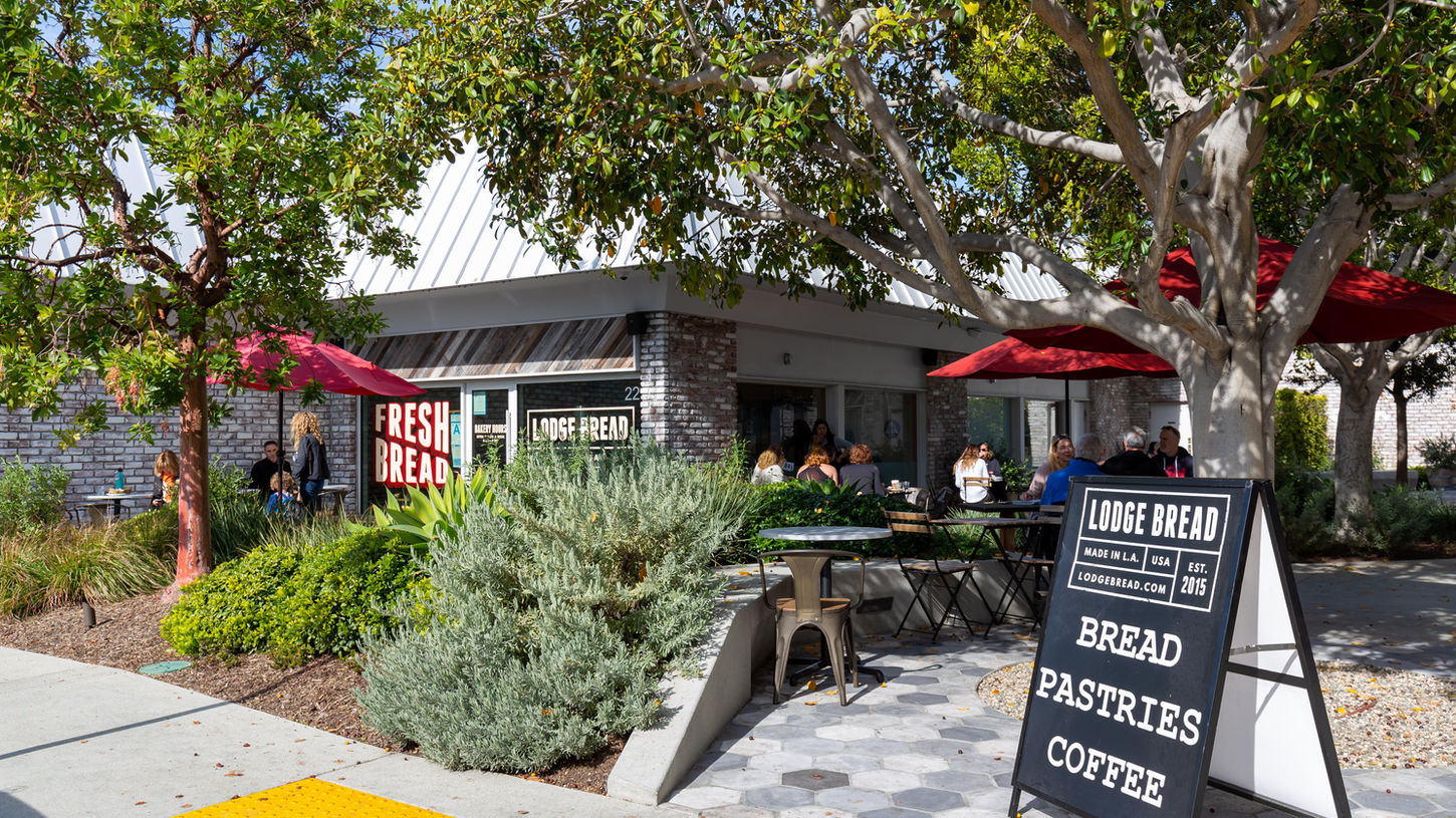 Lodge Bread outdoor patio with customers and menu sign