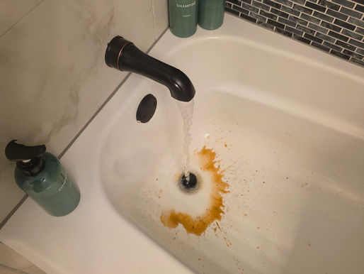 Image of brown water discharge in a bathtub.