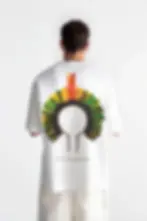 Model wearing KENDZ men’s oversized white t-shirt with headdress back print - streetwear style