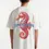 Miniatura: Model wearing KENDZ men’s oversized white t-shirt with seahorse back print - streetwear style