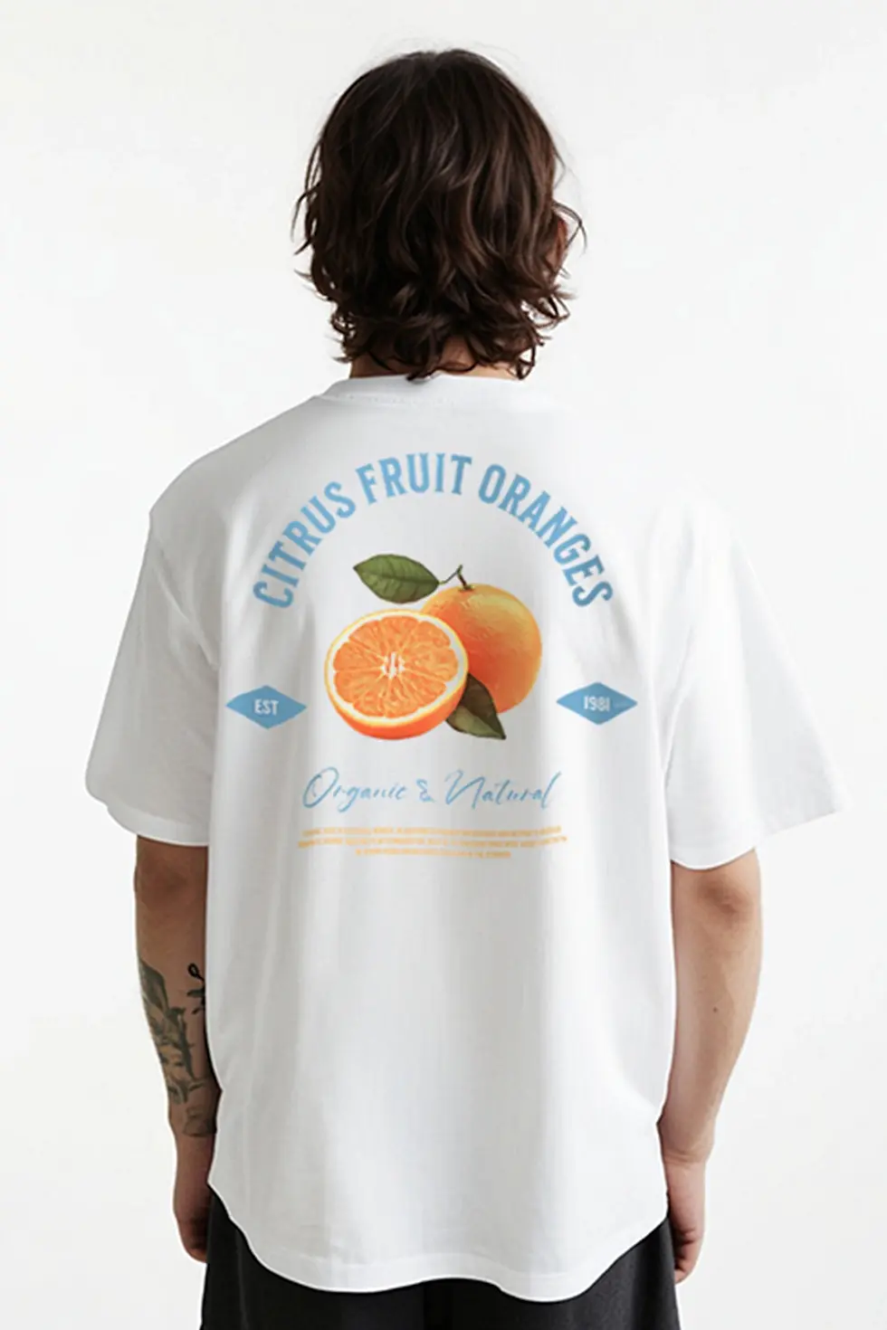 Model wearing KENDZ men’s oversized white t-shirt with orange back print - streetwear style