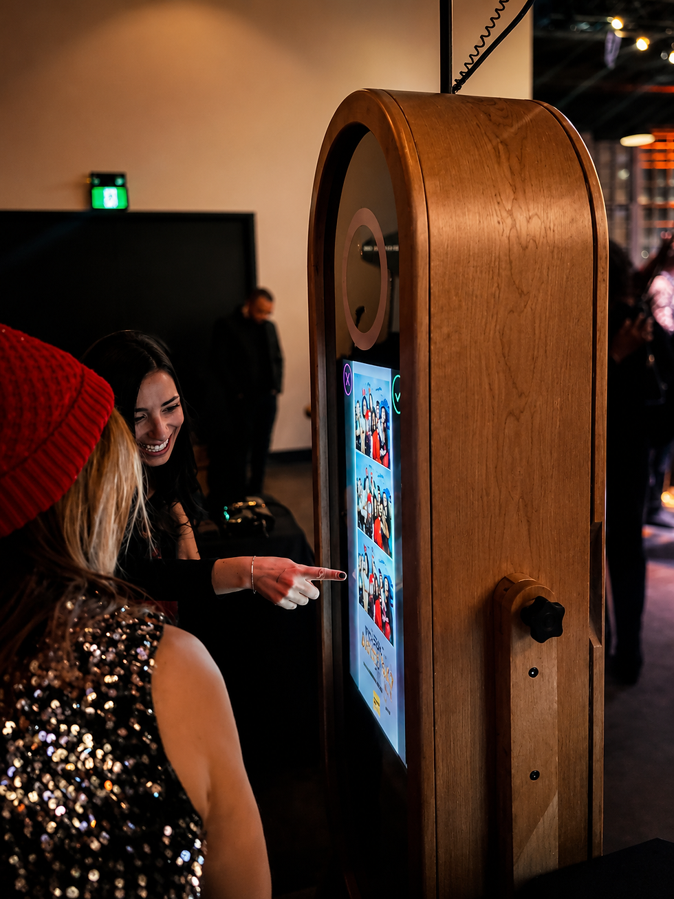 Guests using the Novel Photo Booth mirror booth at Interac's holiday party in Toronto.