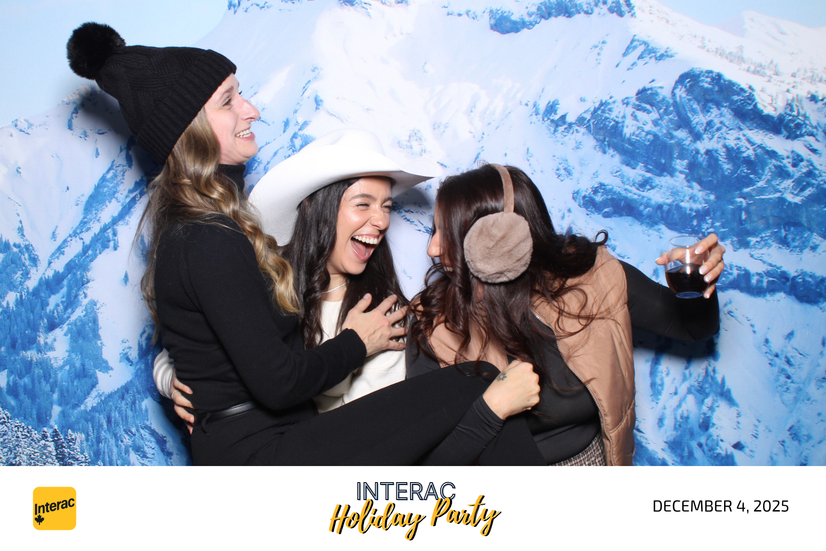 Guests enjoying the custom mirror photo booth at Interac's holiday party with an Après Ski backdrop.