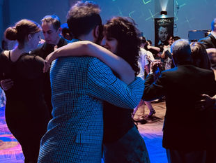 A woman happily dancing tango at a milonga in Buenos Aires