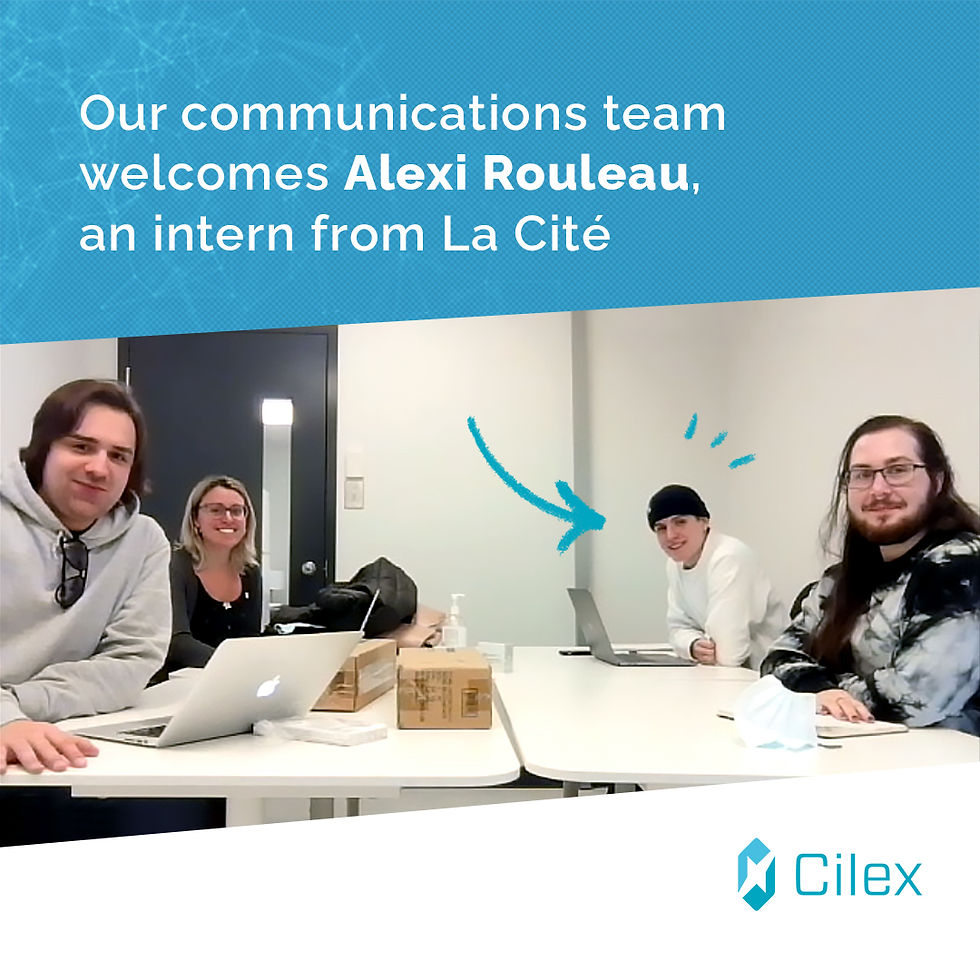 The three permanent members of the communications team along with Alexi Rouleau, sitting around a work table and smiling at the camera.
