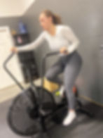 Woman on fitness air bike