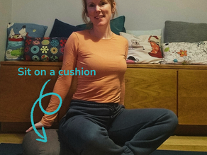 A woman sits cross-legged