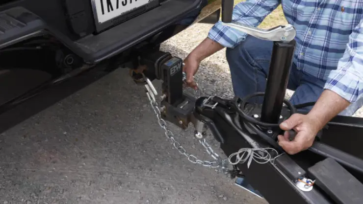 how should a trailer safety chains be attached to the towing vehicle