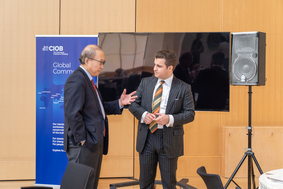 Toronto corporate event photographer capturing two business professionals in conversation during a networking reception.