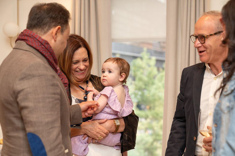 Family interacting with a baby during a first birthday celebration in Toronto