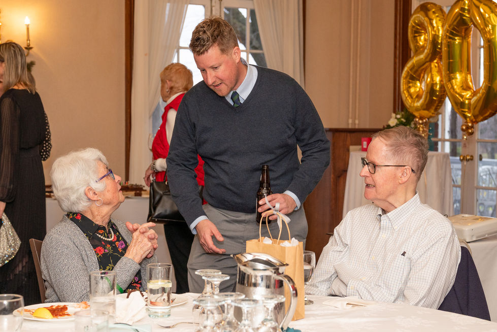 Guests talking at a table during a milestone birthday celebration at Scarboro Golf & Country Club in Toronto.
