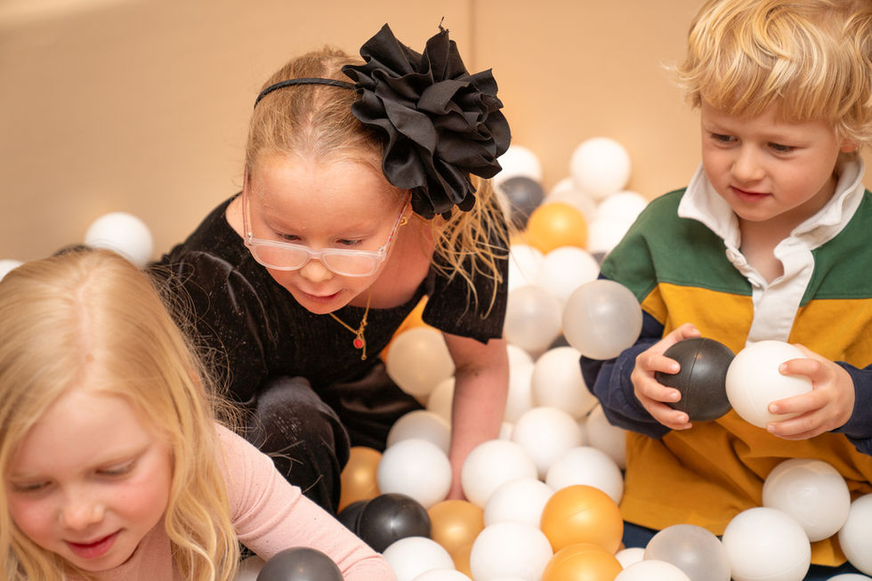 Children playing together in a ball pit during a first birthday celebration in Toronto