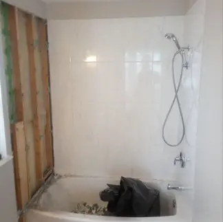 Before and after of a bathroom remodel in Walnut Grove, featuring a custom-built vanity with integrated drawer storage by Cascadia Construction.