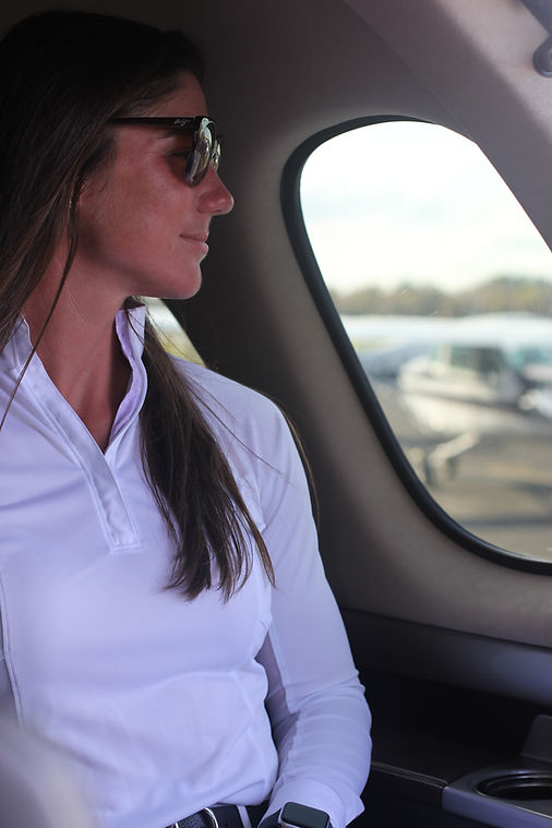 Image of a woman sitting in private charter flight plane with PRP aviation