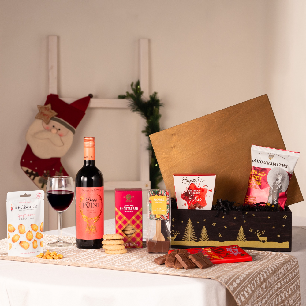 Traditional Christmas hamper with red wine and festive treats