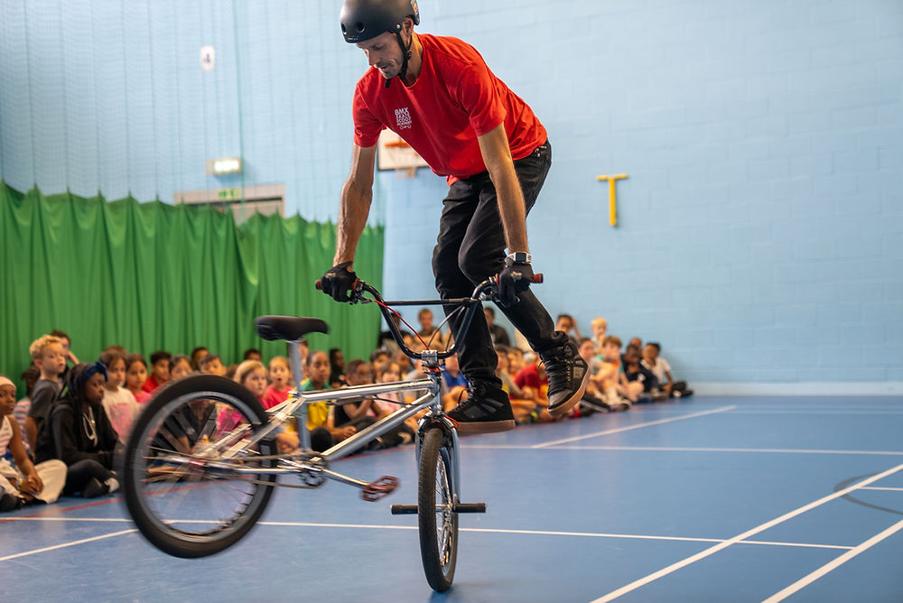 BMX rider performing tricks on his BMX bike as part of our funded HAF programme.