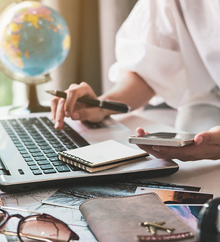 Young traveler planning vacation trip and searching information or booking hotel on laptop