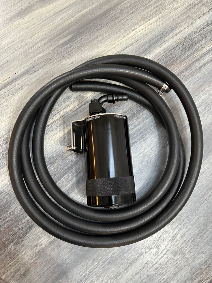 Black automotive component with coiled hose