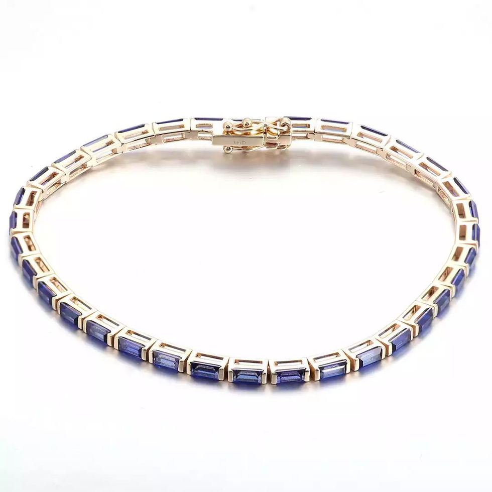14K yellow gold bracelet set with baguette-cut lab-grown blue sapphires in a continuous line setting