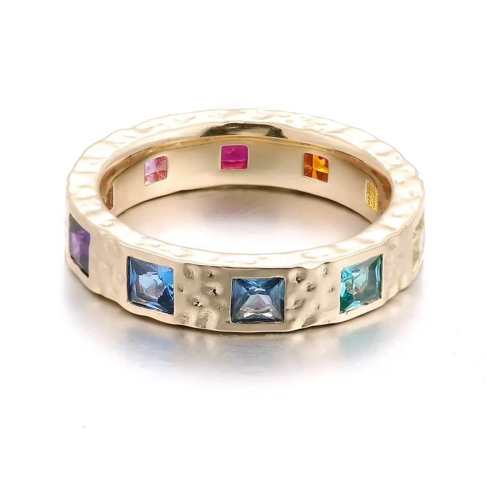 Flush-set rainbow sapphire eternity band in hammered gold